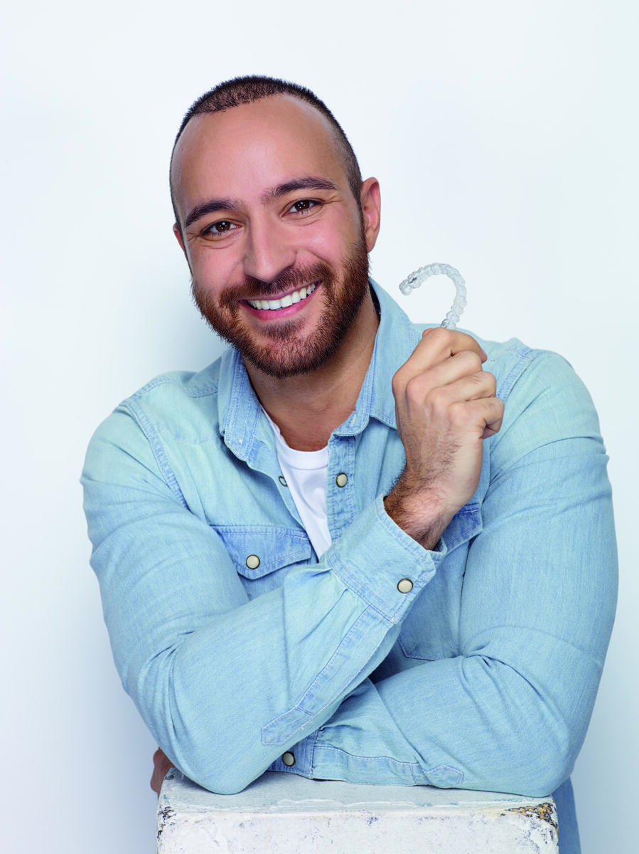 Invisalign promotional photograph showing a clear aligner